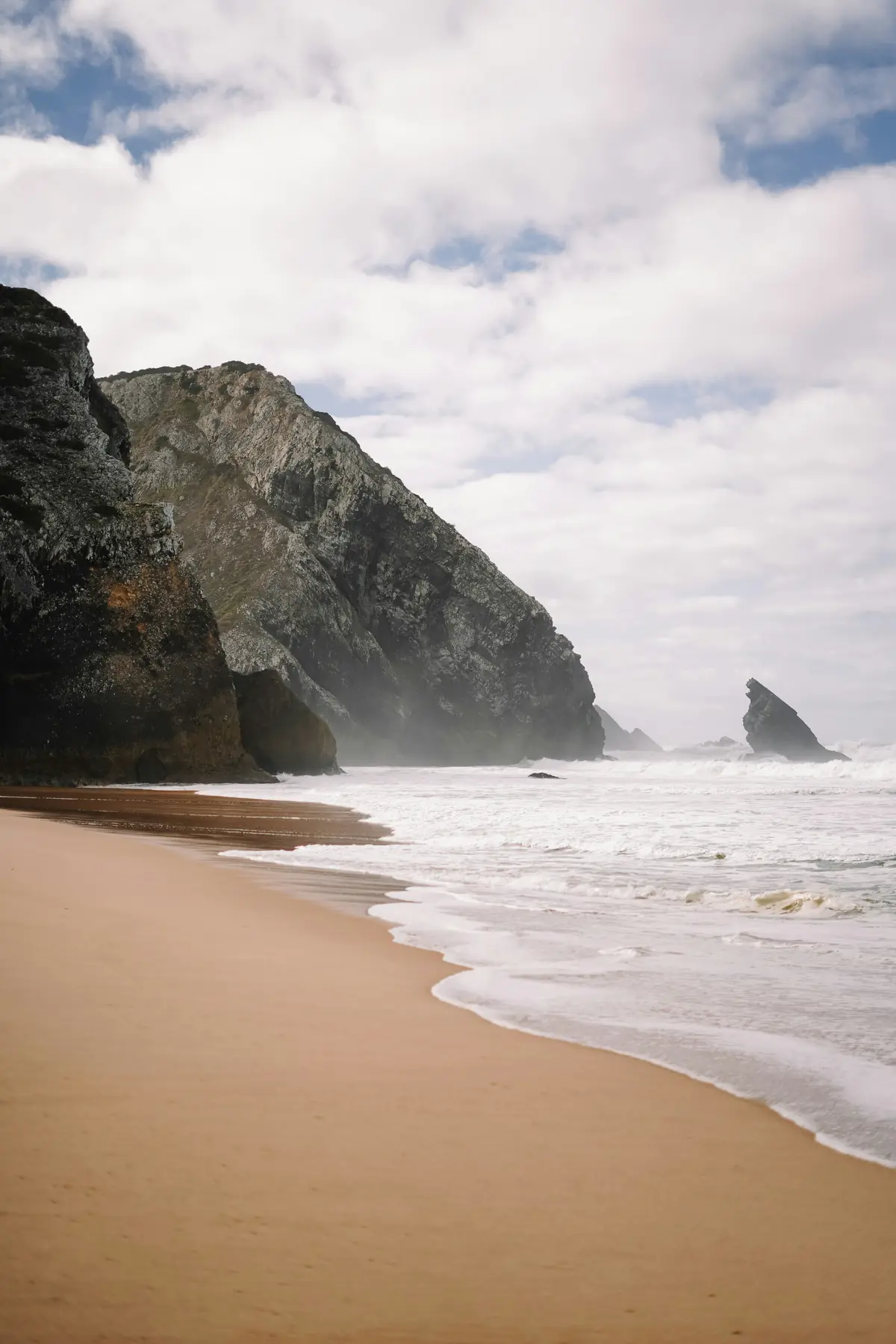 The beach at Adraga with pale surf