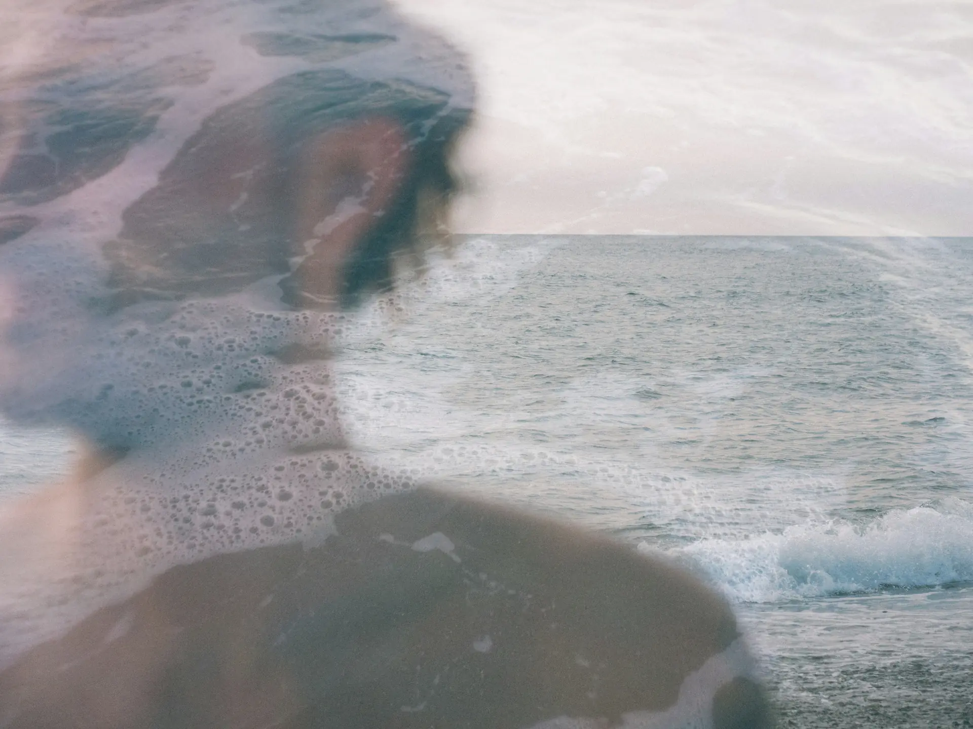 A double exposure of a silhouette above the sea